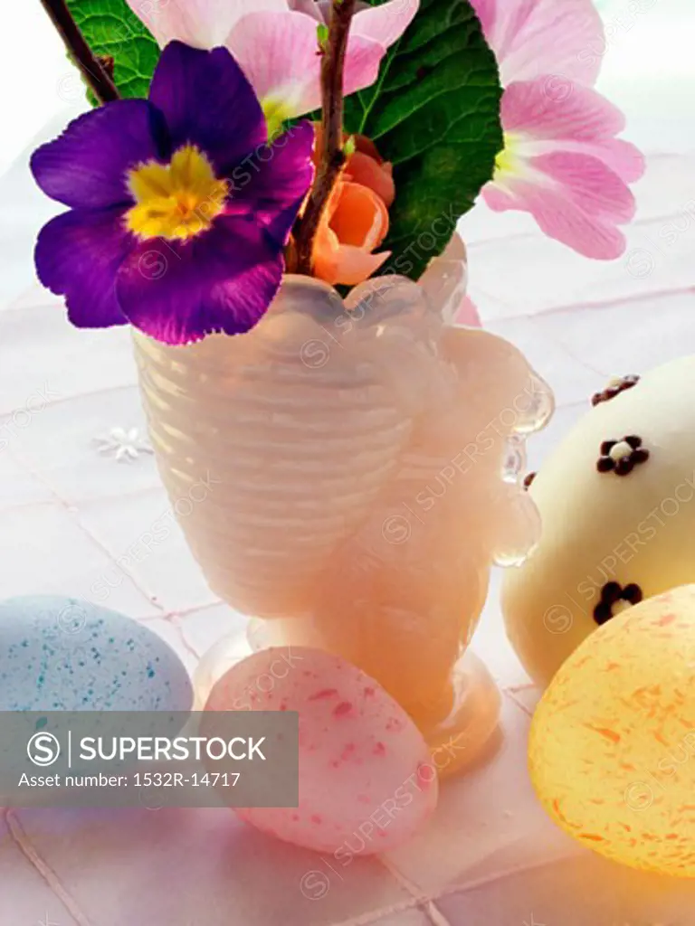 Pastel-coloured Easter eggs and spring flowers