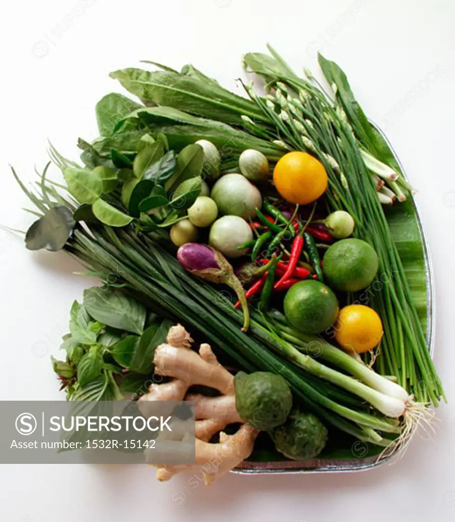 Asian vegetable still life with limes, herbs, ginger