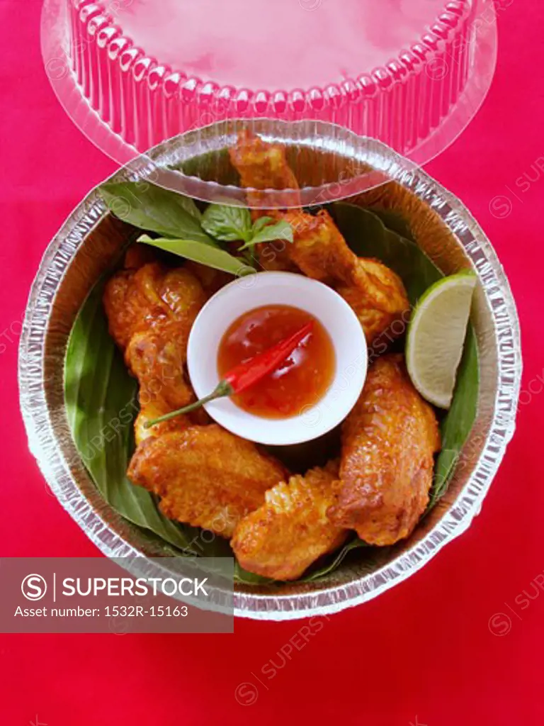 Crispy chicken wings with chili dip in lunch box