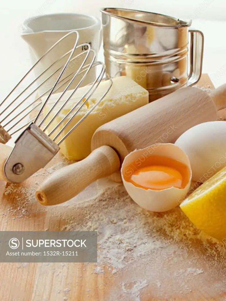 Various baking utensils, eggs, butter and lemon
