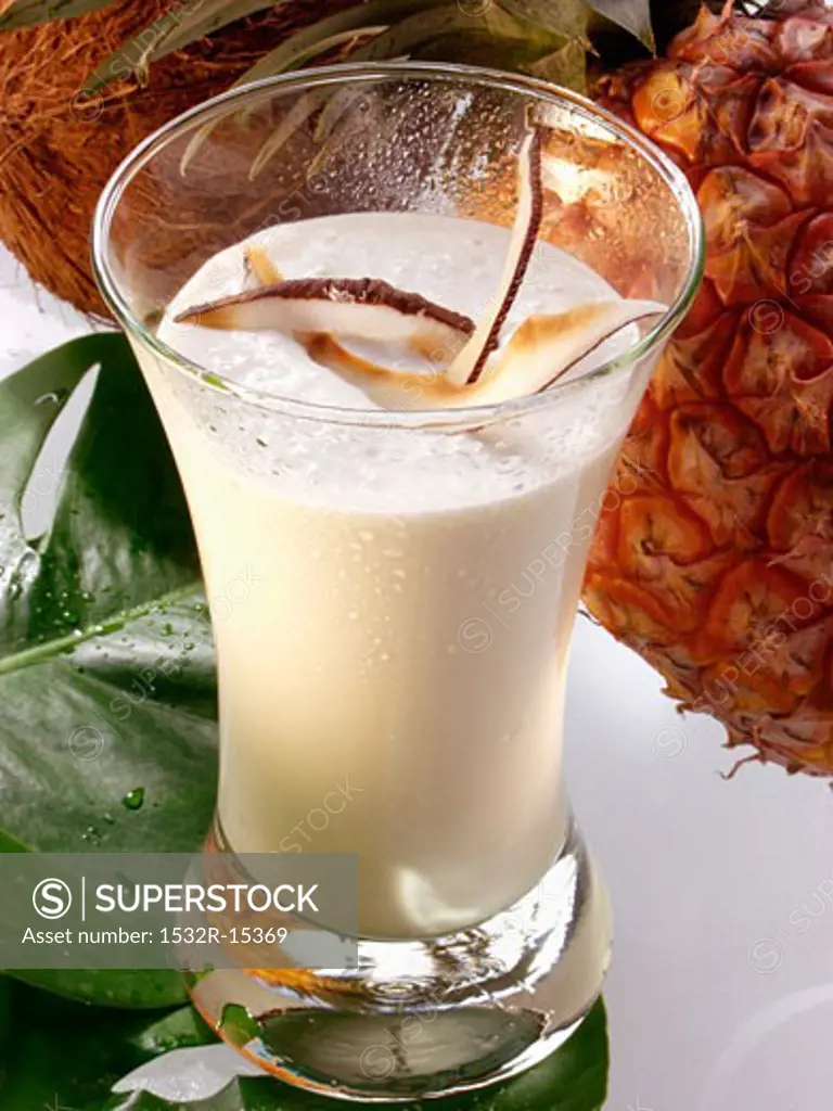 Exotic pineapple and coconut shake in glass