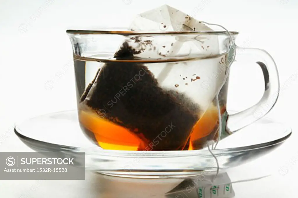 Freshly made tea in glass cup with tea bag