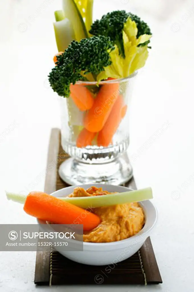 Celery, broccoli and carrots in glass, carrot dip
