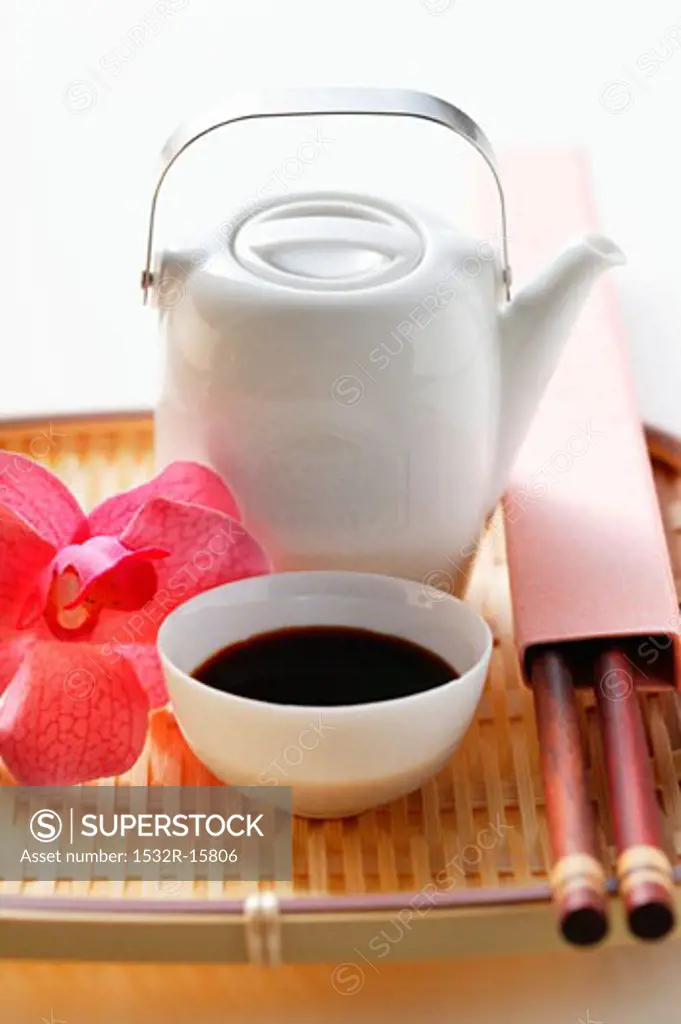 Small white jug for soy sauce, chopsticks and flower