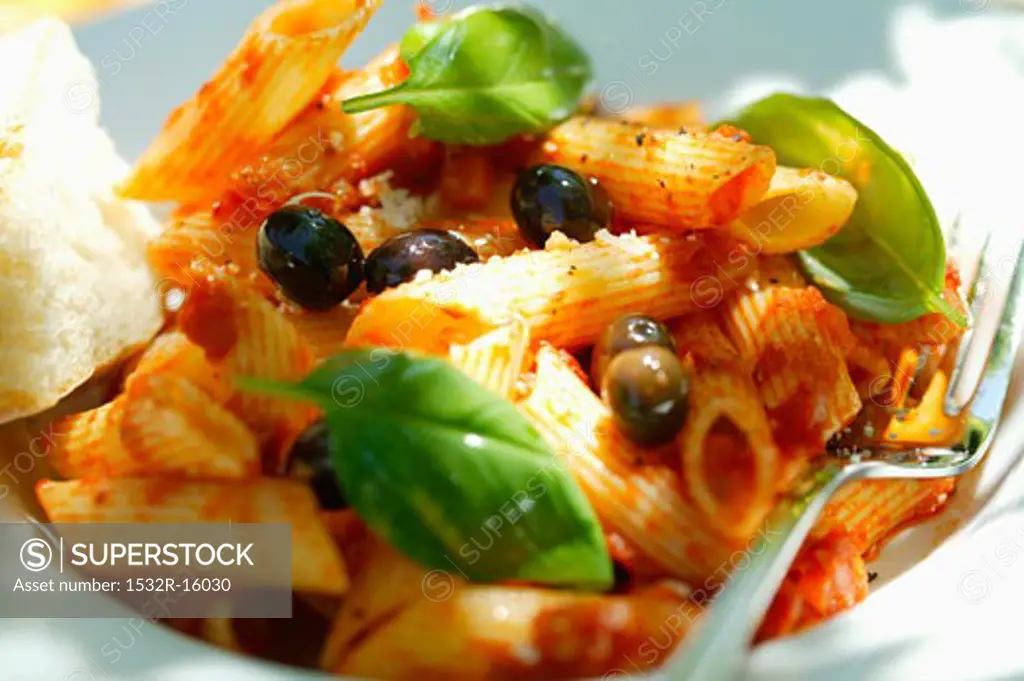 Penne rigate with tomato sauce, olives and basil
