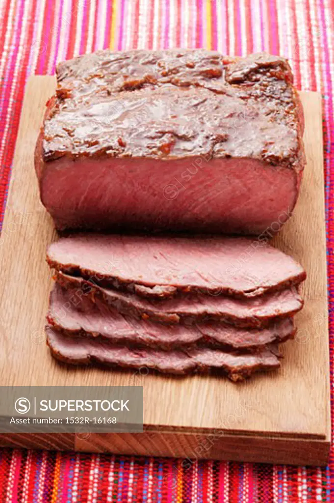 Roast beef on chopping board