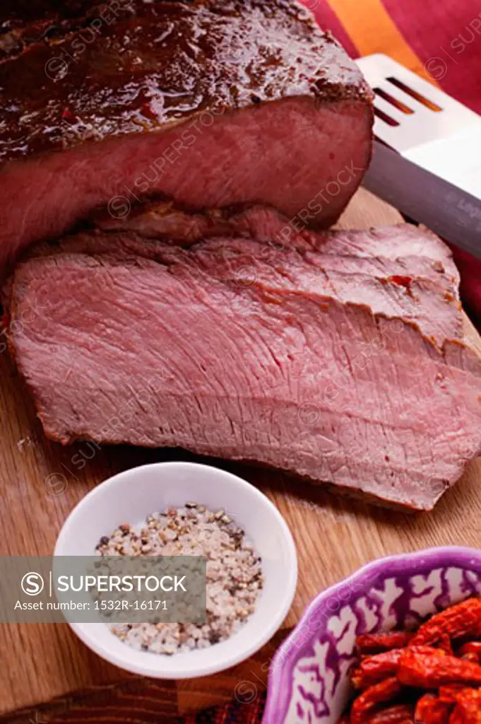 Roast beef on chopping board, spices