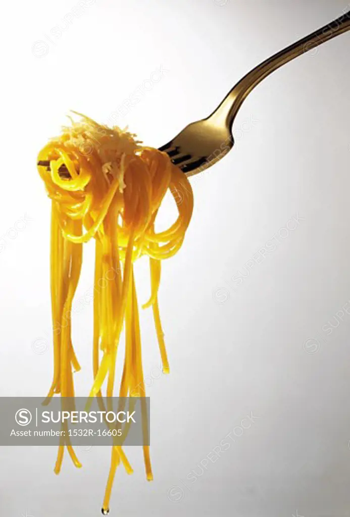 Spaghetti aglio e olio with Parmesan on fork