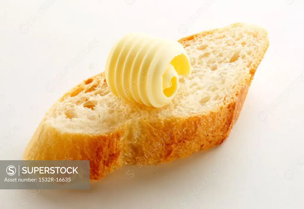 Slice of baguette with a butter curl