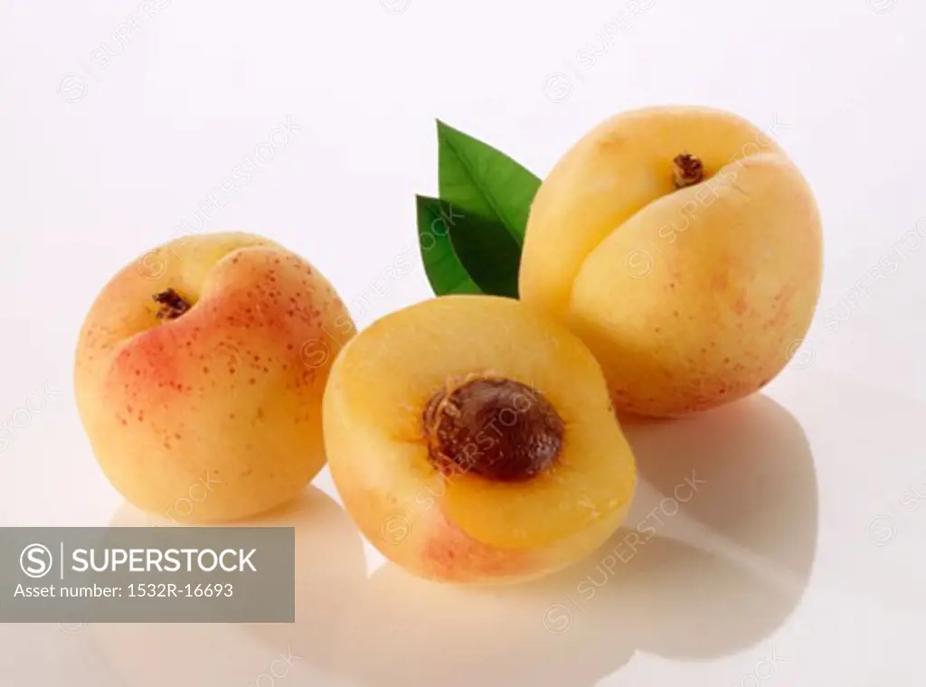Two whole apricots and half an apricot