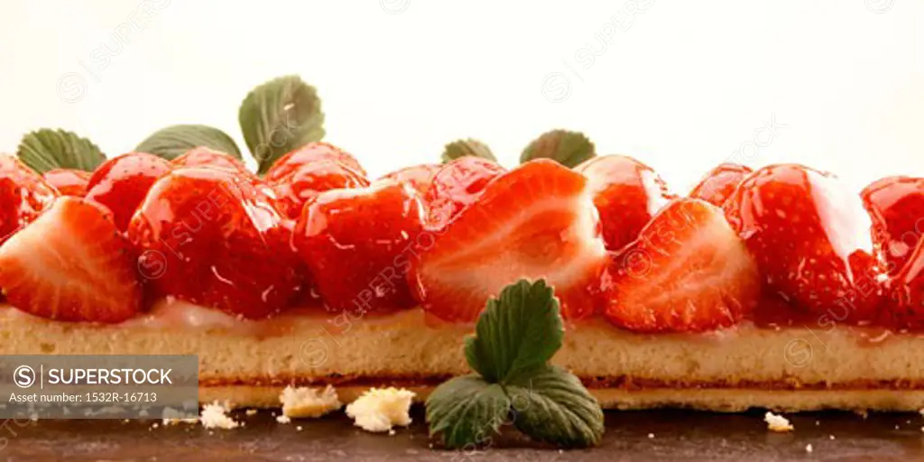 Strawberry cake with mint leaves (close-up)