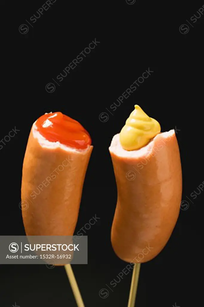 Sausages with ketchup & mustard on wooden cocktail sticks