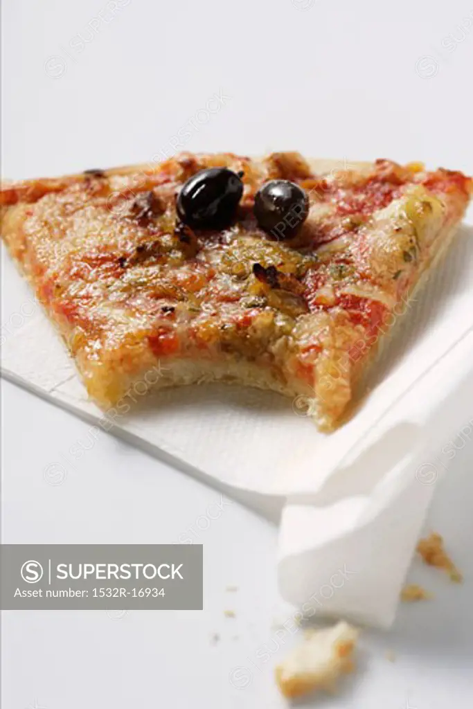 Piece of pizza with tuna and olives, a bite taken