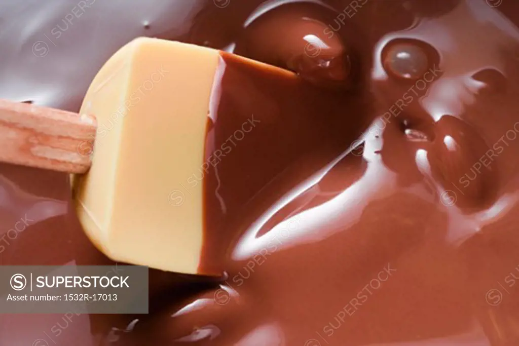 Melted chocolate with mixing spoon
