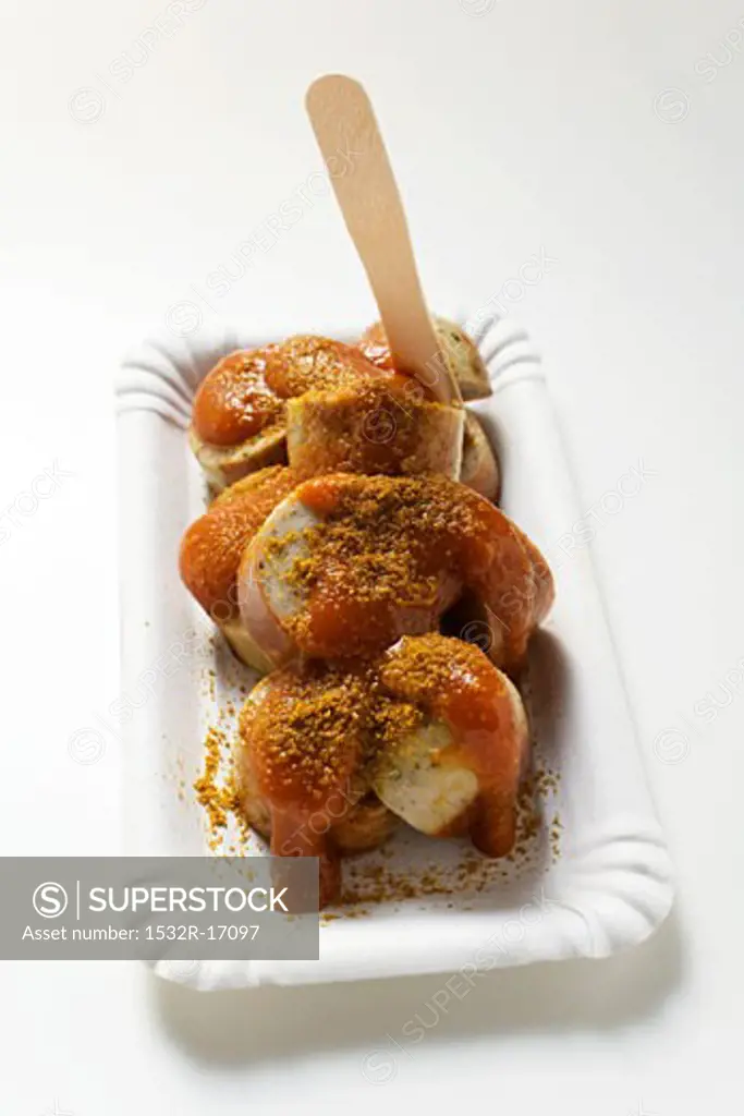 A currywurst (sausage with ketchup & curry powder) with wooden fork