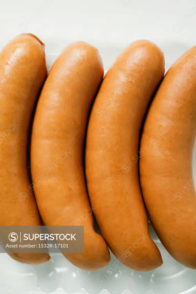 Four bockwurst (German sausages) in a plastic tray