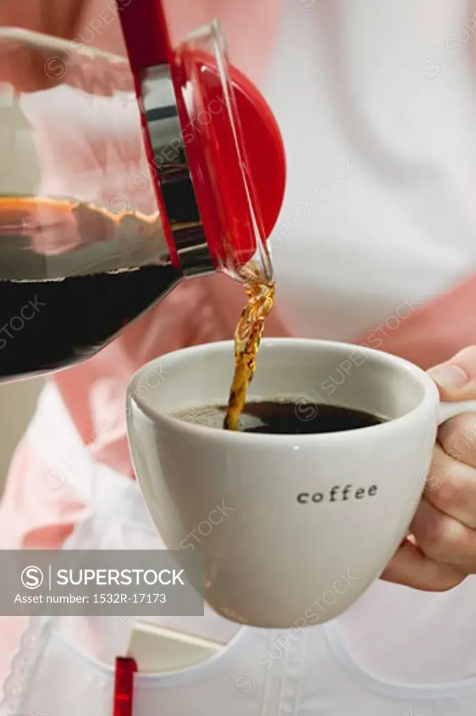 Pouring coffee into a cup