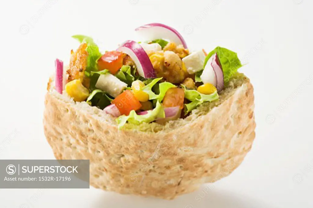 Pita bread filled with vegetables and roast turkey breast