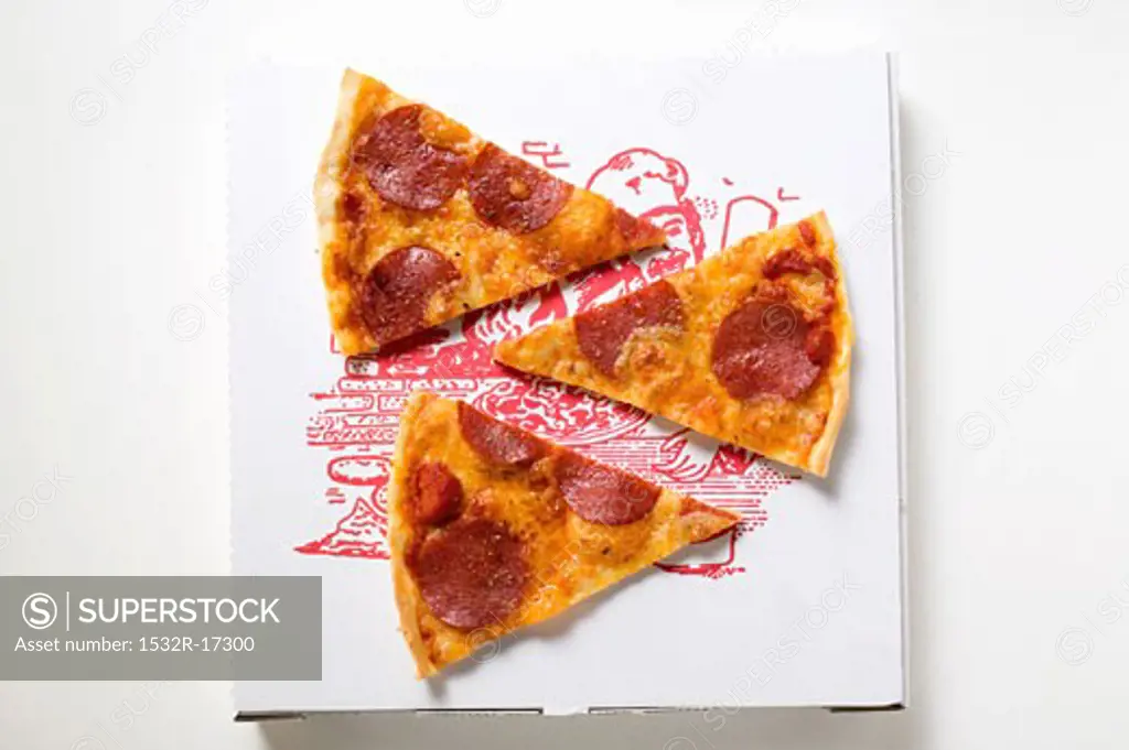 Three slices of pepperoni pizza on pizza box