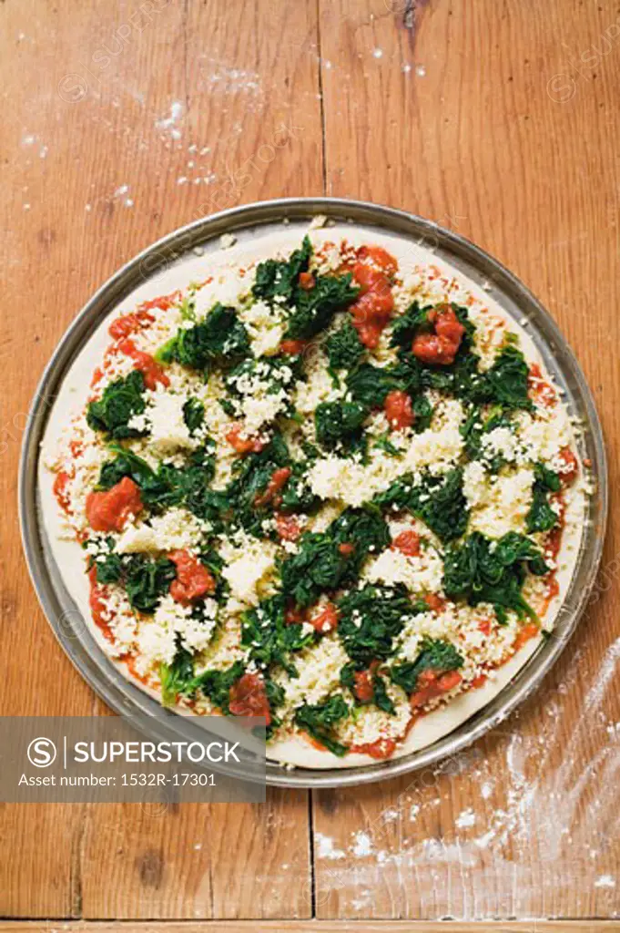Spinach, tomato and cheese pizza (unbaked)