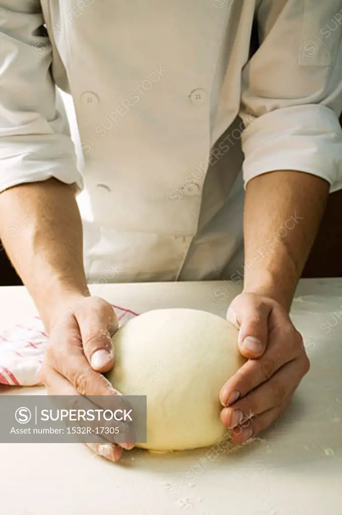 Forming pizza dough into a ball