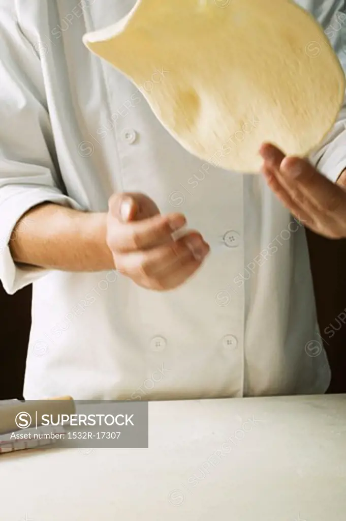 Shaping pizza dough (throwing it in the air)