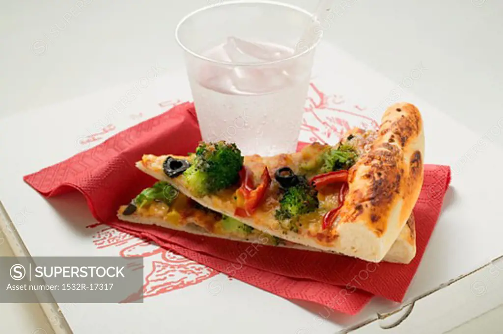 Two pieces of American-style vegetable pizza & mineral water