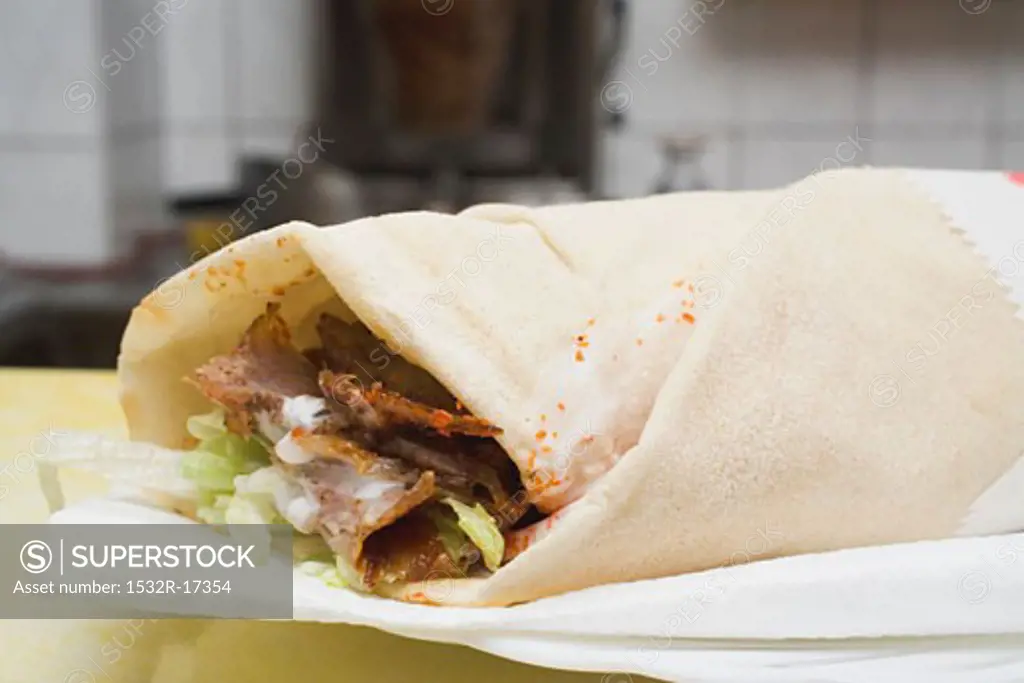 Döner wrap on paper napkin in snack bar