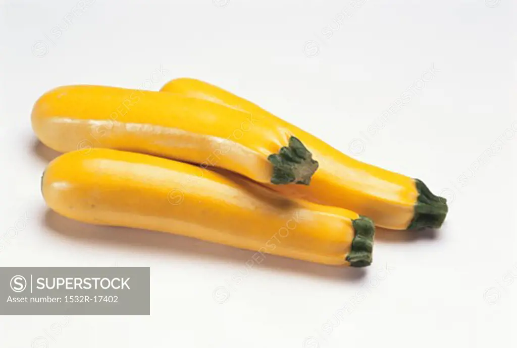 Three yellow courgettes