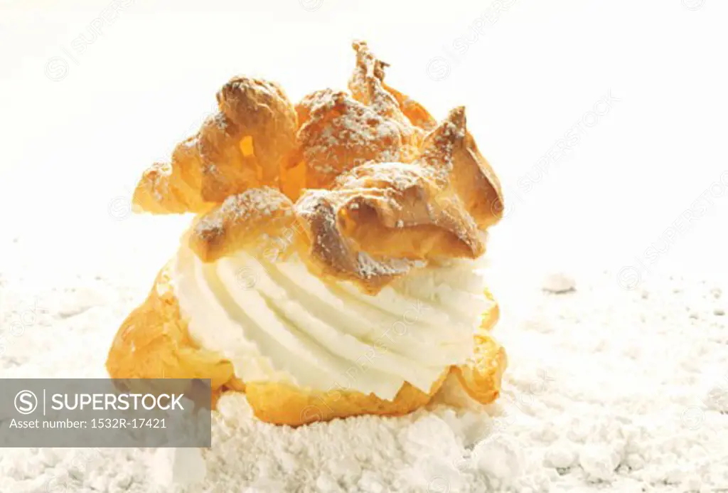 Cream puff with cream and icing sugar