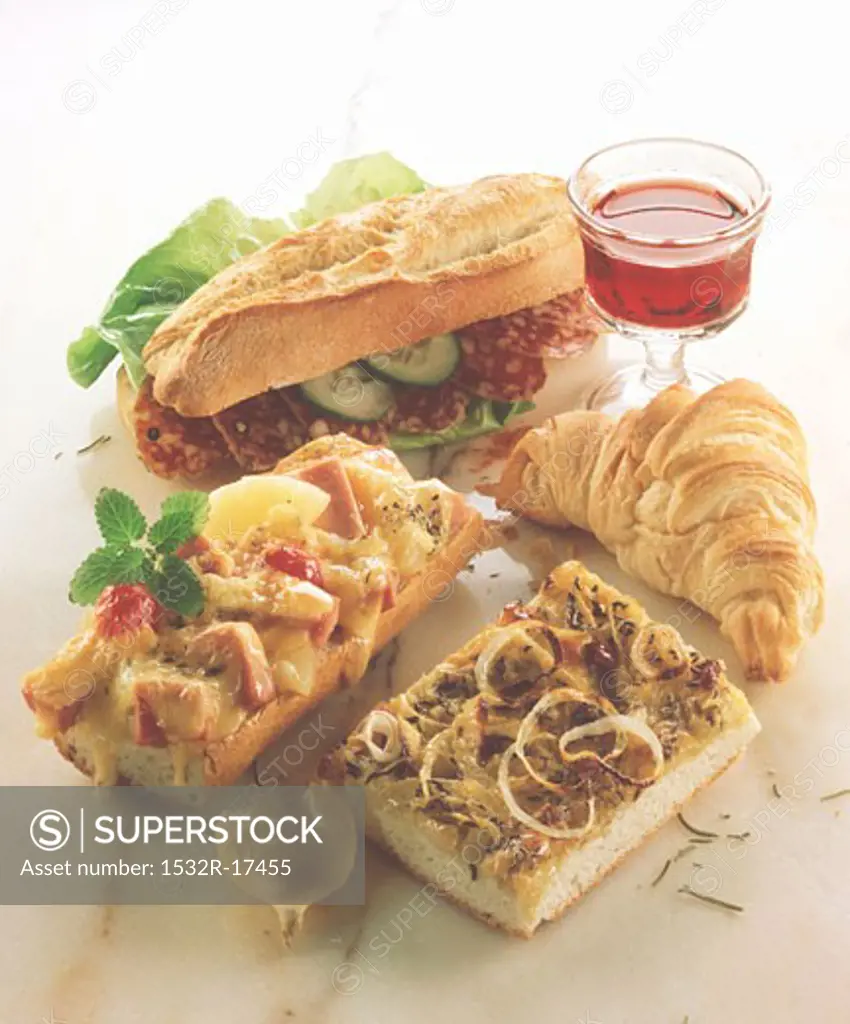 Assorted snacks: sandwich, baguette, pizza, croissant