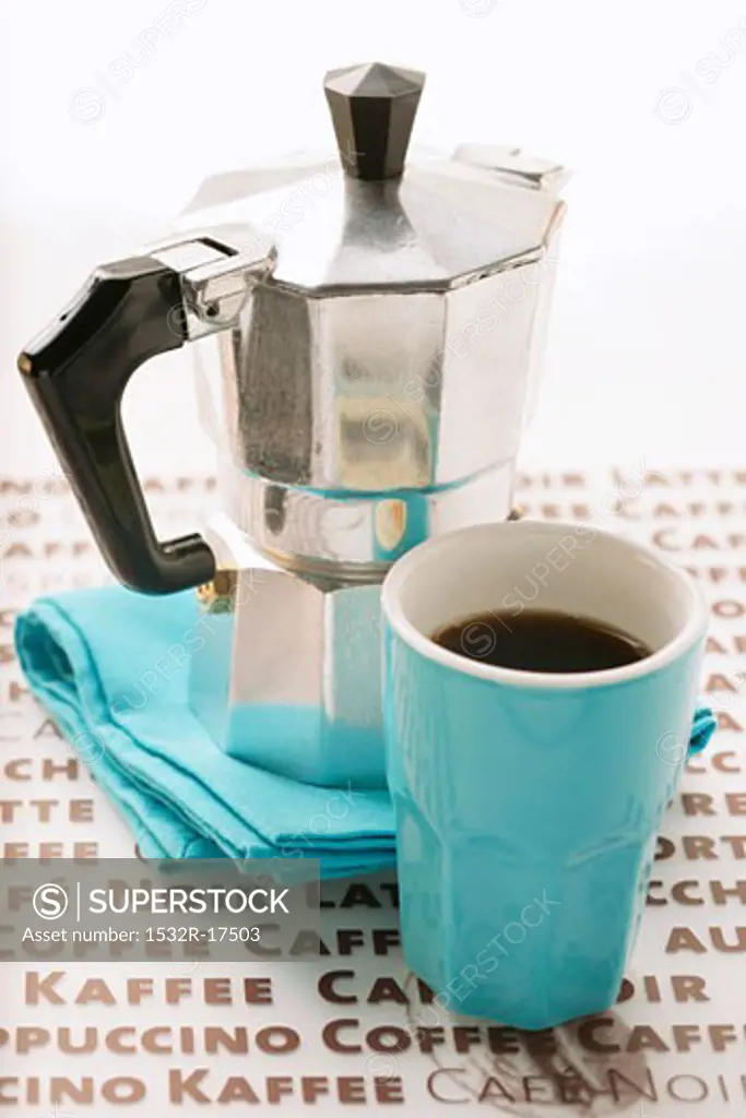 Blue espresso cup in front of espresso machine