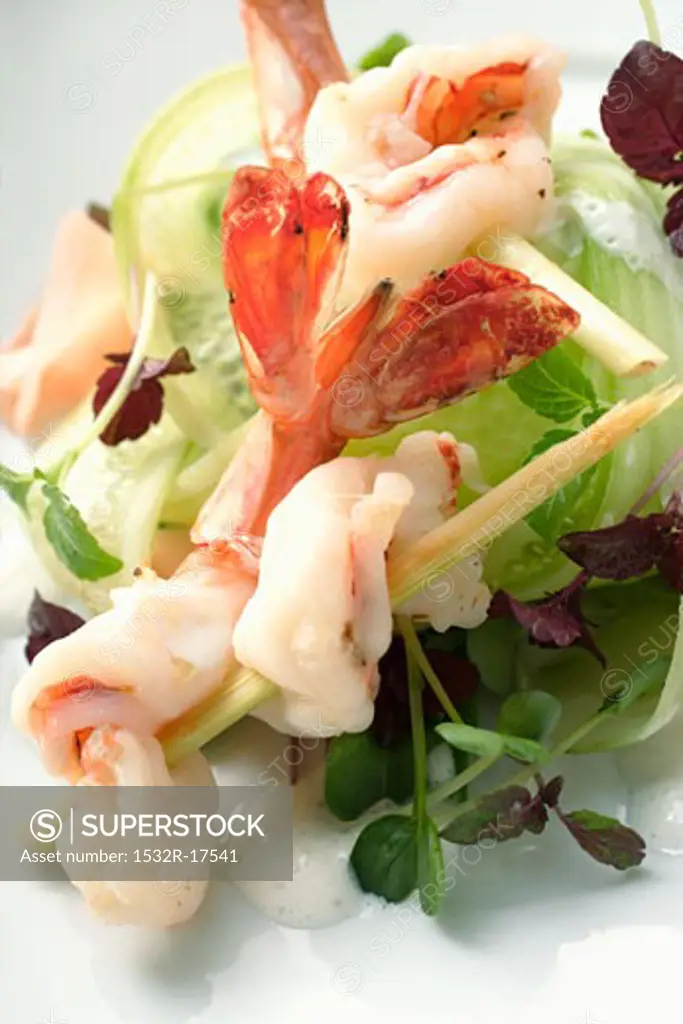 Salad with shrimps skewered on lemon grass