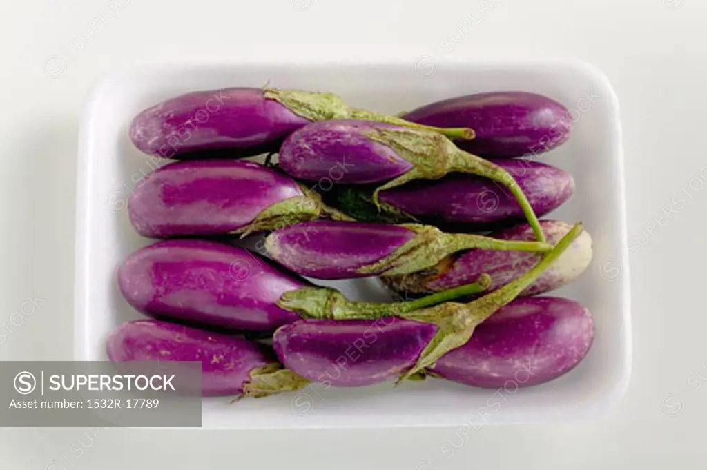 Baby aubergines in white dish