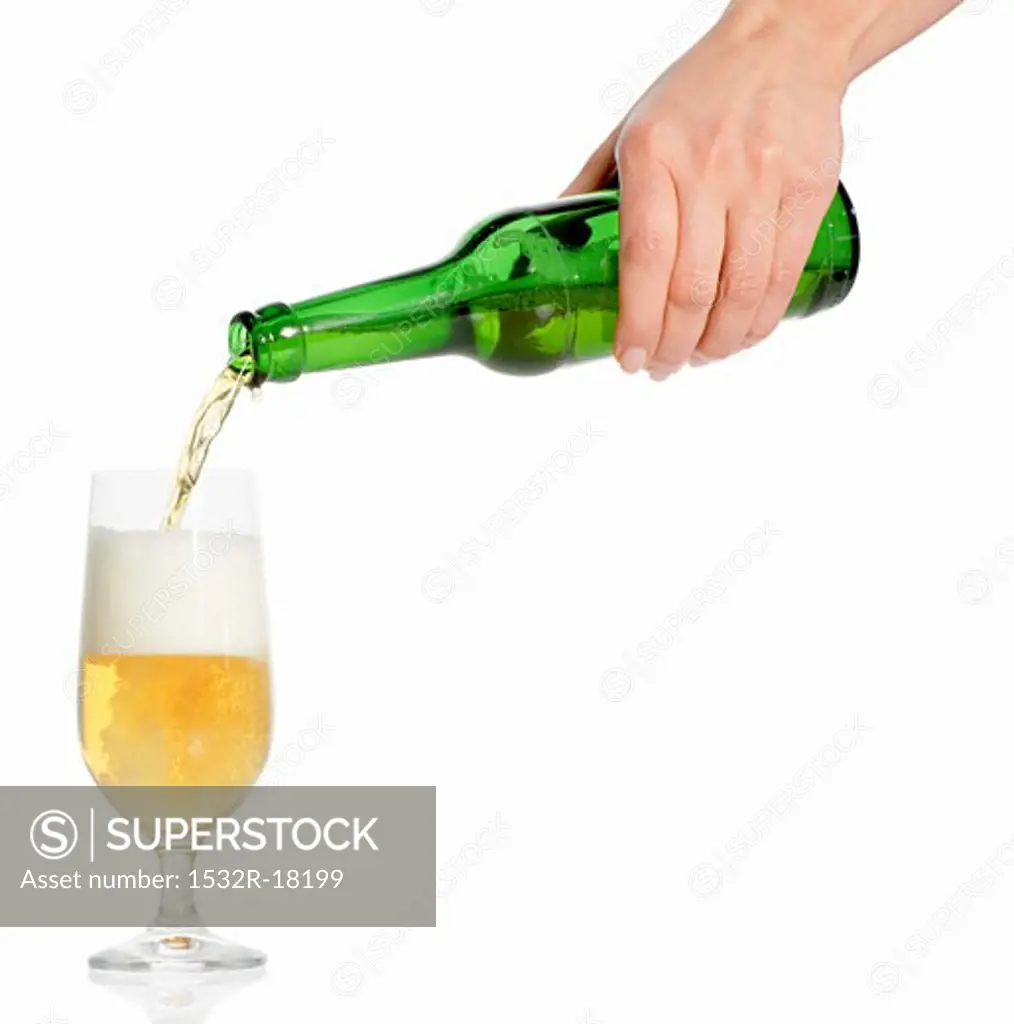 Woman's hand pouring beer