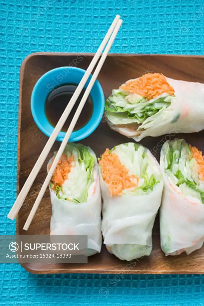 Rice paper rolls with soy dip and chopsticks