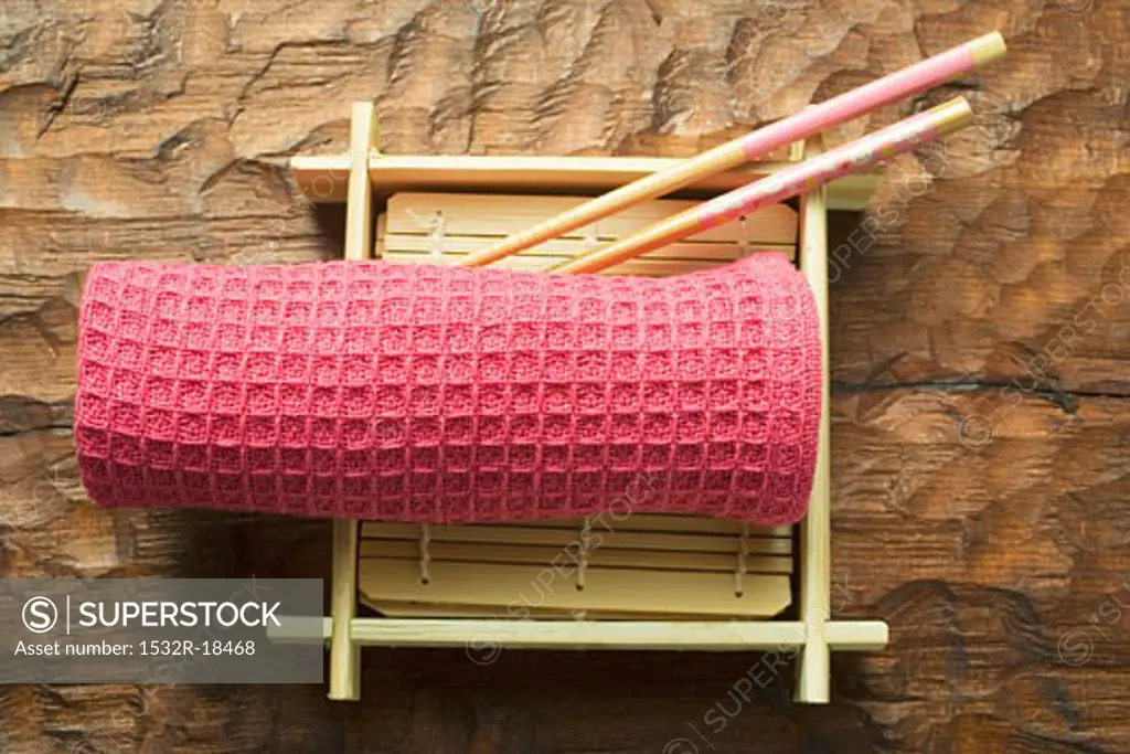 Asian table accessories: hand towel, chopsticks, bamboo mat