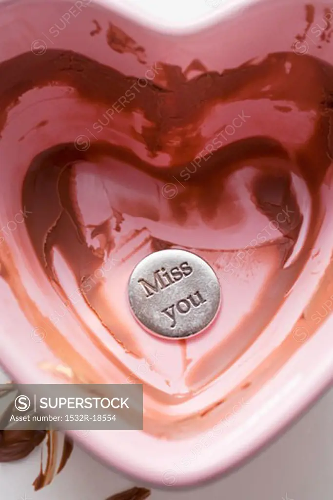 Heart-shaped bowl with remains of chocolate sauce