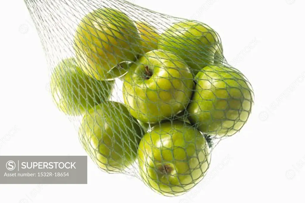 Granny Smith apples in green string bag