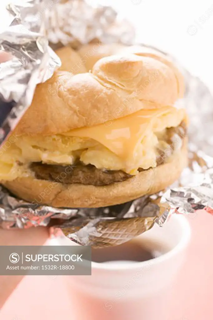 Cheeseburger with scrambled egg in aluminium foil