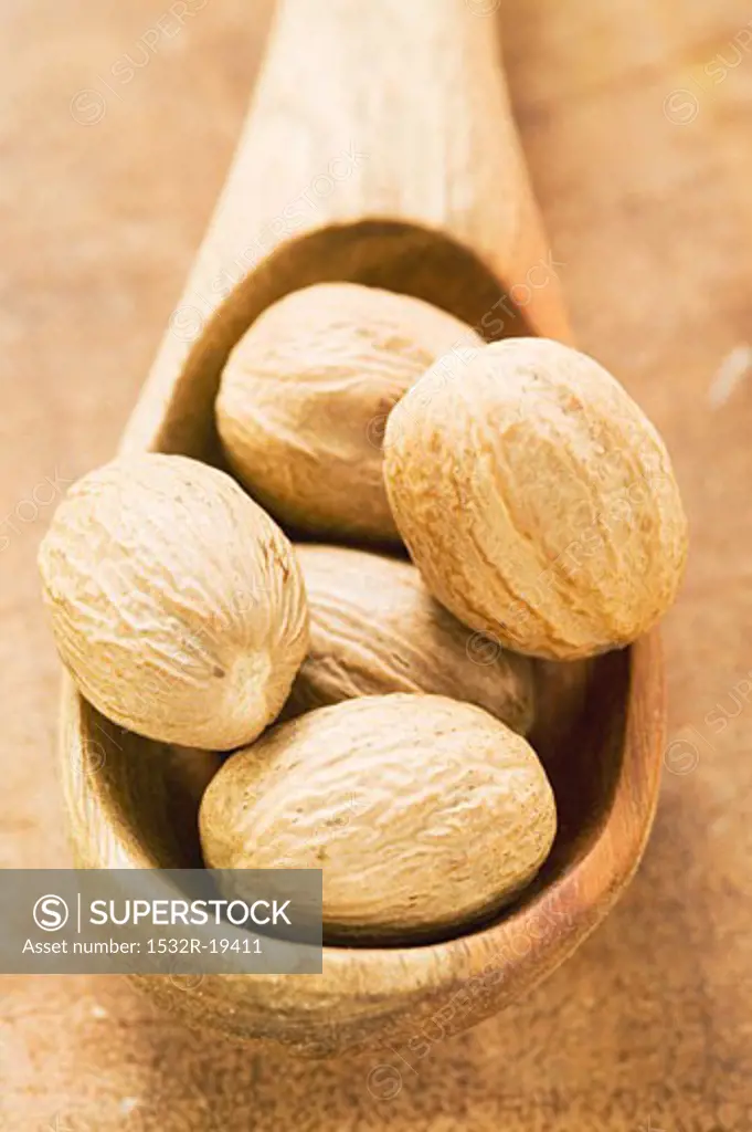 Nutmegs in wooden spoon