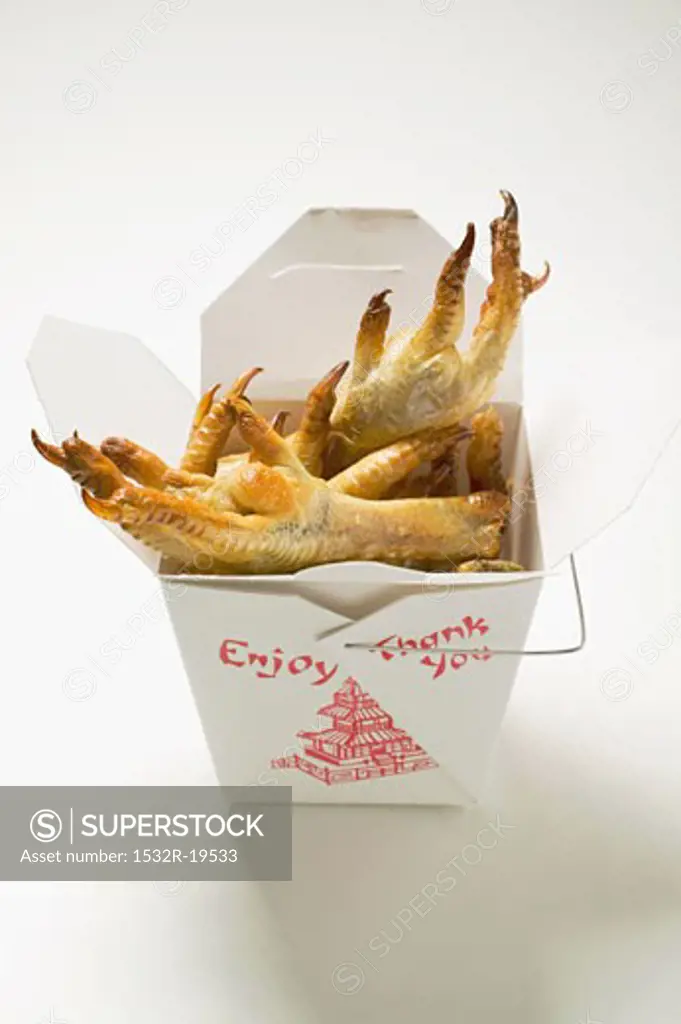 Deep-fried chicken feet to take away (Asian snack)