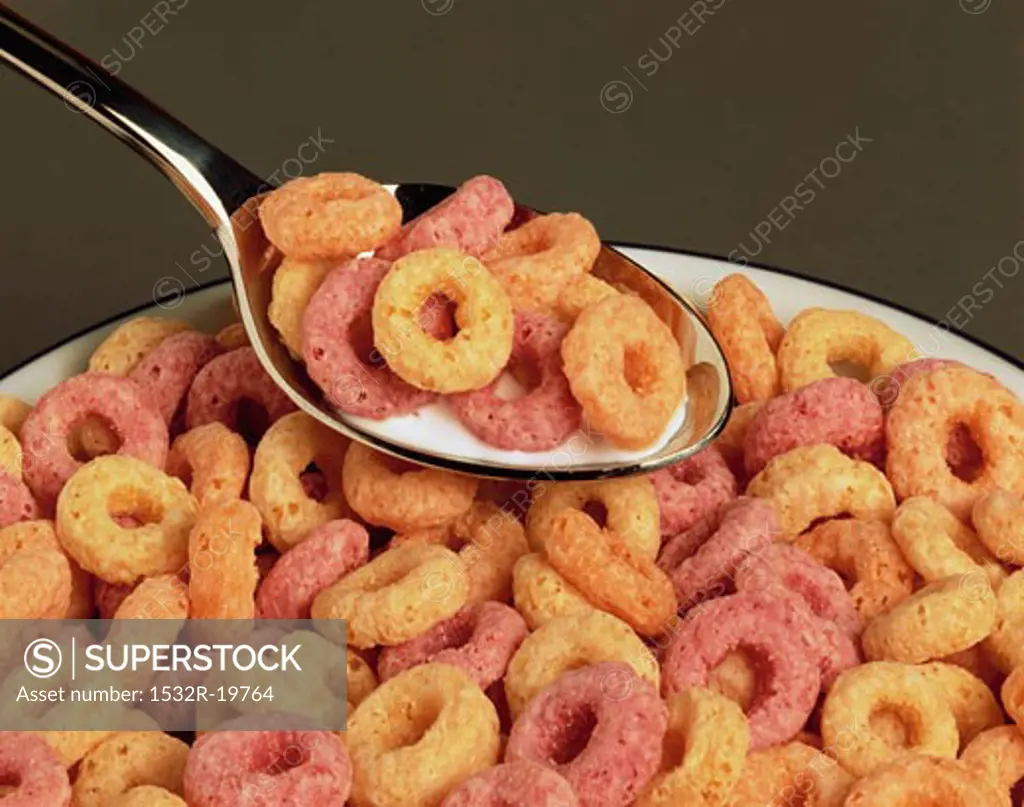 Cereal with milk on spoon and in bowl