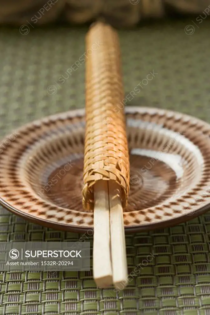 Chopsticks in woven case on plate