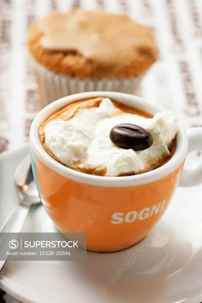 Cup of espresso with whipped cream and mocha bean