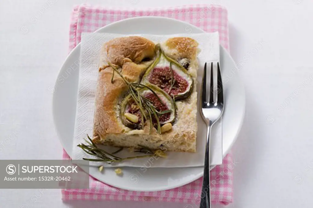 Piece of focaccia with figs, rosemary and pine nuts