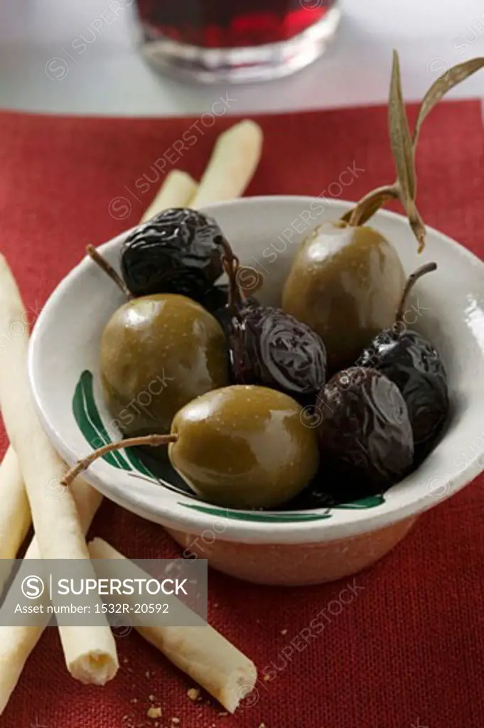 Black and green olives with grissini