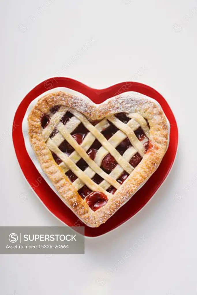 Cherry pie on heart-shaped plate