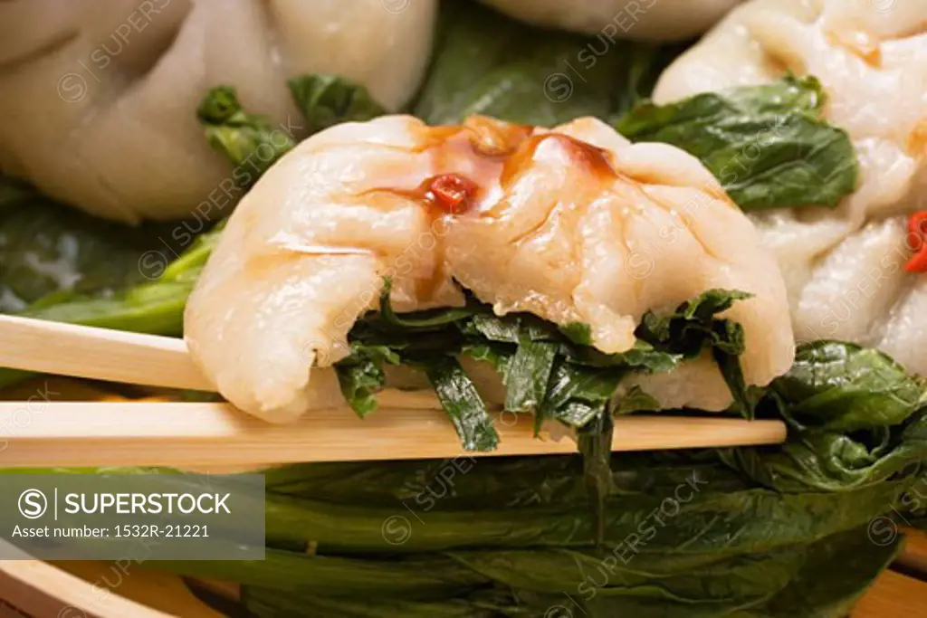 Yeast dumplings with chive filling on pak choi (Thailand)