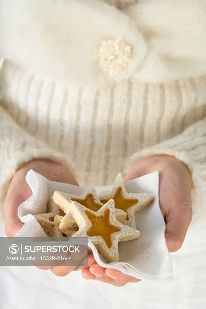 Woman holding star-shaped biscuits